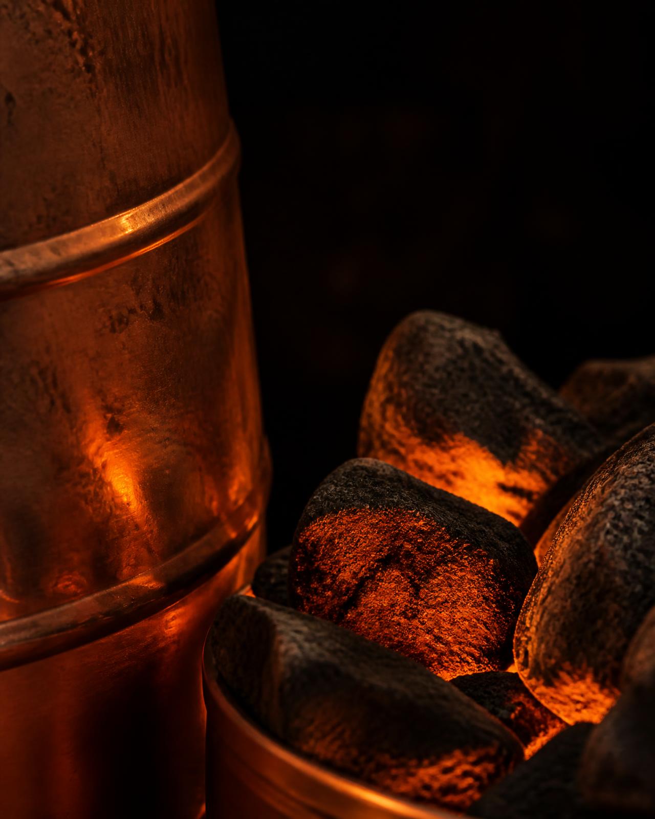 Glowing sauna stones and burnished copper