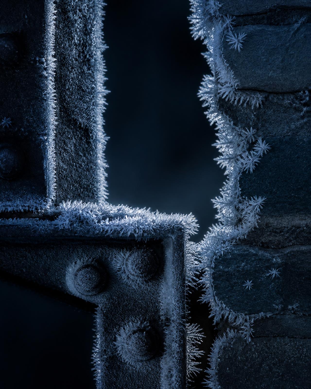 Rime ice crystals forming on dark steel